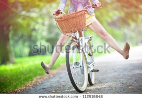 stock-photo-woman-riding-bicycle-with-her-legs-in-the-air-112916848